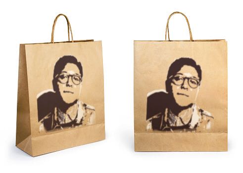 Childs face stenciled onto two gift bags
